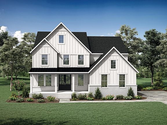brick and board and batten house with front porch