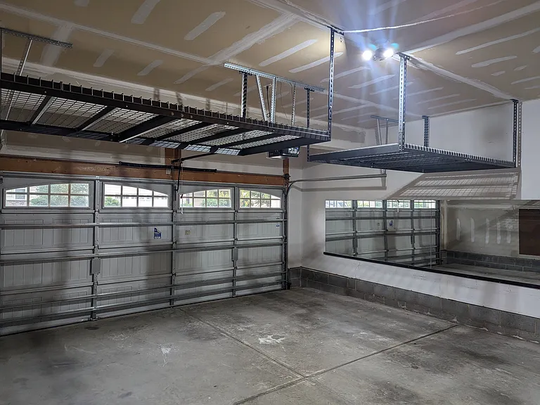 2 car garage with large storage above. Large mirrors on wall if you want to convert into a home gym.