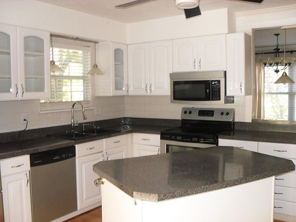KITCHEN WITH white cabinets, dishwasher, micowave, range, and refrigerator