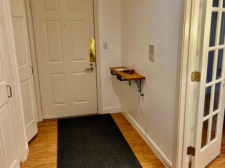 Hallway, facing front door + french doors into master bedroom.