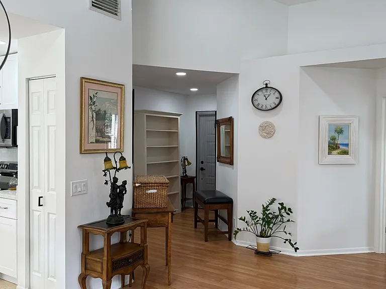 view from the living room towards the entrance and into the kitchen