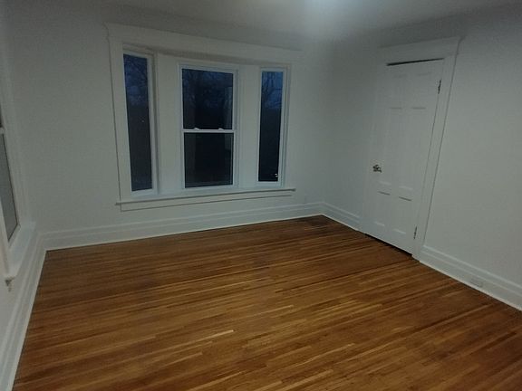 spacious bedroom with fresh paint, refinished original hardwood flooring and large closet for storage
