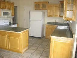 Remodeled kitchen offers tons of cabinet space, upgraded maple cabinets and la