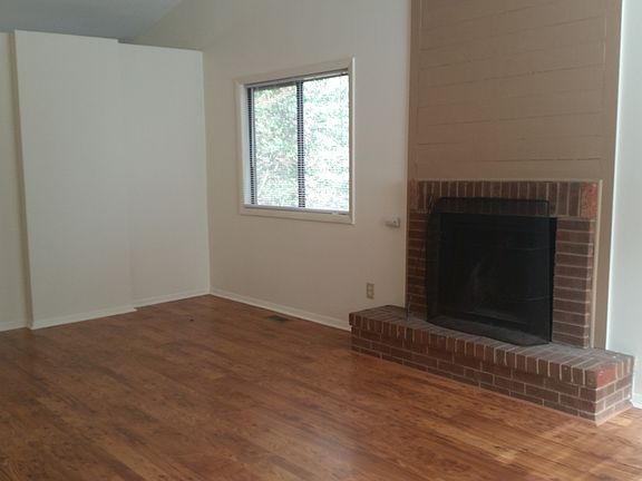 Living room with vaulted ceiling and fireplace