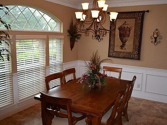 Dinning features arched windows, decorative tile flooring and upgraded light fixtures.