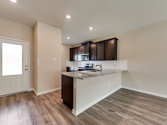 The entry of the Driftwood is highlighted by this stunning 3 4 lite front door.