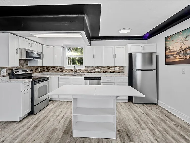 Open modern kitchen with stainless steel appliances