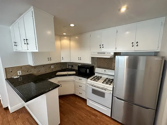 This is a wonderful high-efficiency kitchen with granite countertops, and lots of cabinet space. It is open to the living room, creating more volume to both areas.