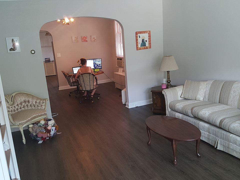 Living room view to dining room with updated laminate flooring.