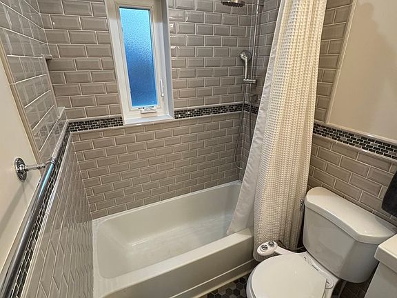 Downstairs full bathroom with custom tile