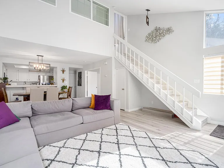 Bright and airy open concept living room with vaulted ceilings