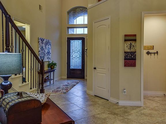 Looking back towards the front door, 2nd bedroom downstairs to the left. Notice the drop zone area from the garage on the right