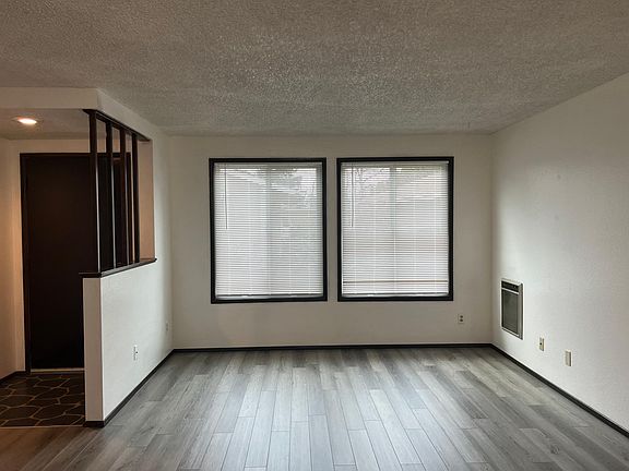living / dining room open concept with new floors looking onto your walkway