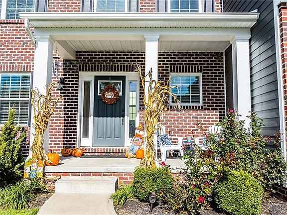 The front porch is very welcoming with mature landscaping and a nice sitting area.