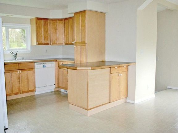 Kitchen with tall cabinets and plenty of counter space. Love the large breakfast bar extra eating area here too!