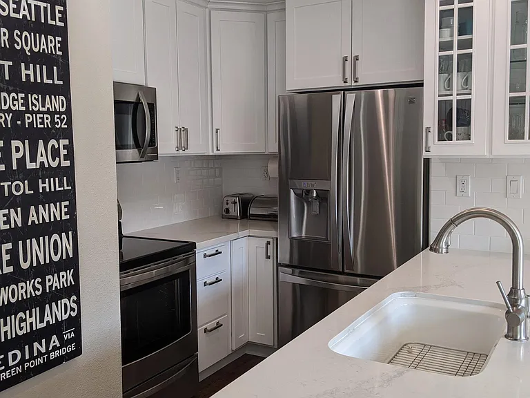 White kitchen cabinets, stainless steel appliances, quartz countertops. All recently redone. Dimmers on all light switches.