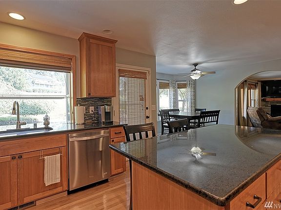 Kitchen - Huge chef kitchen with lots of storage, including walk-in pantry, custom mini-bar, new maple cabinets with pull-out drawers and service trays.  There's even a cabinet with pull out garbage and recycle bins! Kitchen also includes stainless steel appliances, over the stove water pot filler, stylish tile back splash with granite counters and mini-breakfast bar. What more could you ask for?!