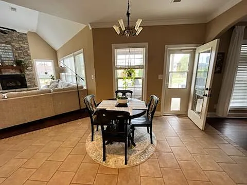 Kitchen opens to a tiled eating area overlooking the spacious backyard