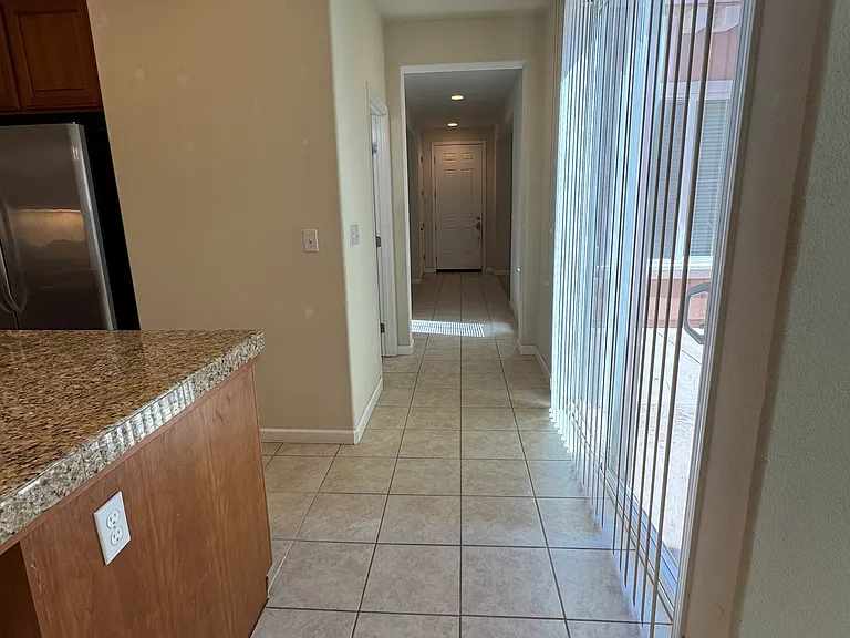 Hallway Leading to Downstairs 1/2 Bath, Formal Dining Room, Living Room & Front Door