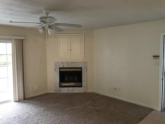 Living room with fireplace and double glass doors to private patio