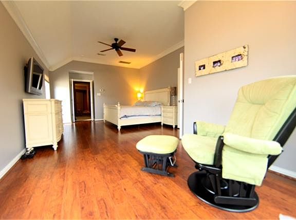 Master bedroom has hardwood floors, high ceilings and sitting area