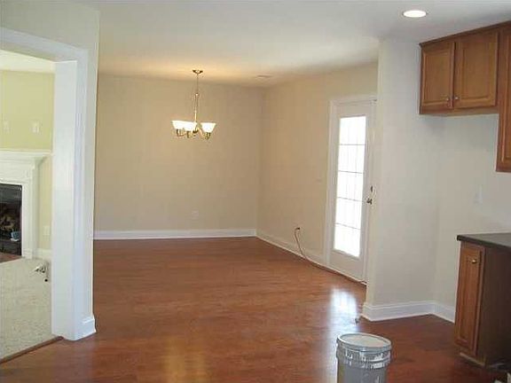 check out these gleaming hardwoods in the dining area!! beautiful kitchen!