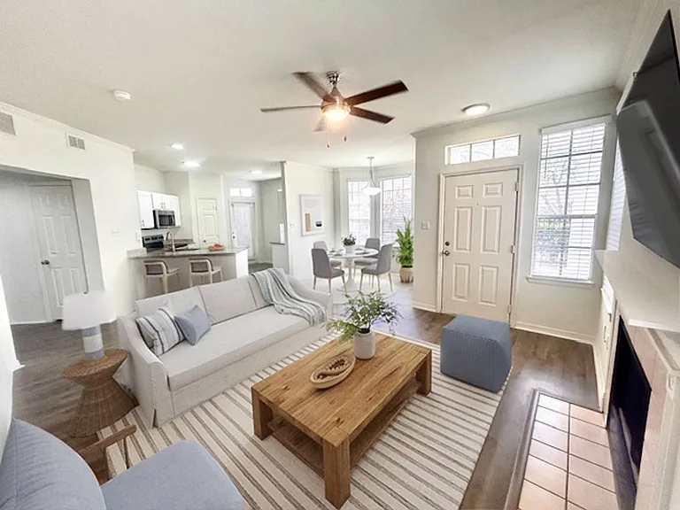 Living room with a fireplace feature and sunlit layout at Windsor Highwoods Preserve apartments