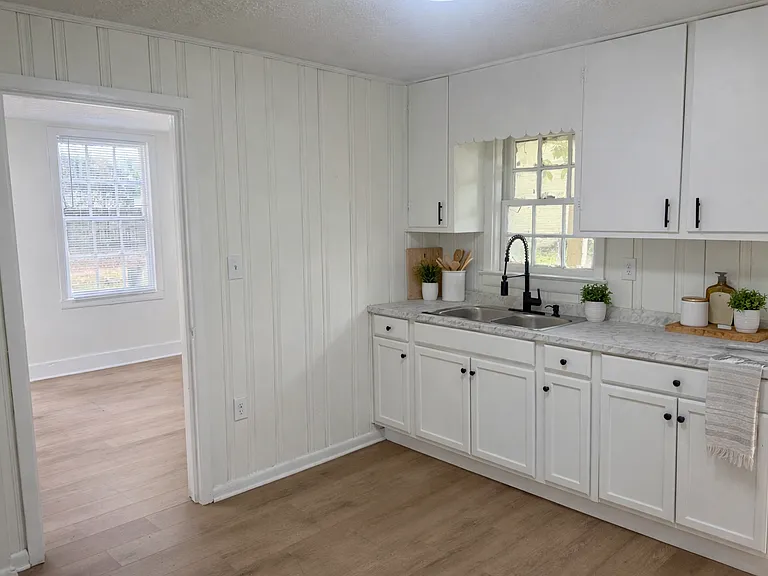 Updated kitchen showing layout and connection to living space