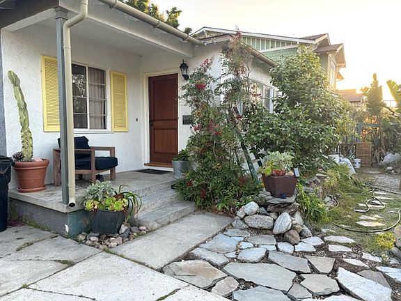Top of the hill sunsets and ocean breezes for this very private front yard outdoor patio living space.