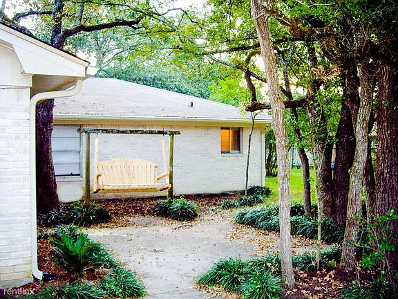 Huge shaded back yard with bench swing