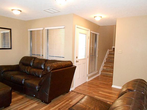 Another view of living room. Stairs lead to upstairs bedroom and loft. There is a half bath near the stairs.