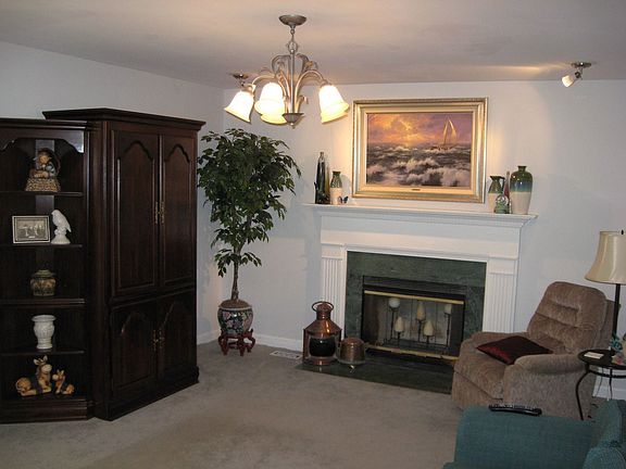 Fireplace in living room for added warmth in this large and spacious home.