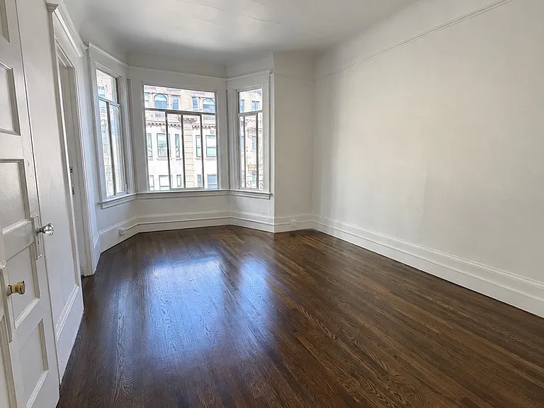 1st bedroom with bay windows and closet. Freshly refinished and stained floors throughout. Access to bathroom from both bedrooms.