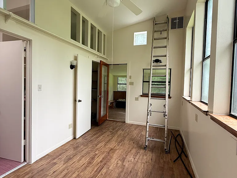 Studio with bathroom access, large closet, and an enclosed porch at the far end.