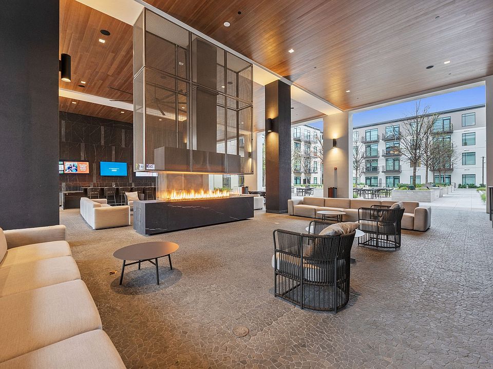 Hangout at The Piazza, our covered outdoor lounge including televisions, fireplace and lounge seating.