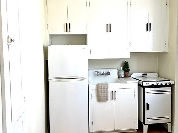 Kitchen features a gas stove, quartz countertop, and deep cast iron sink.
