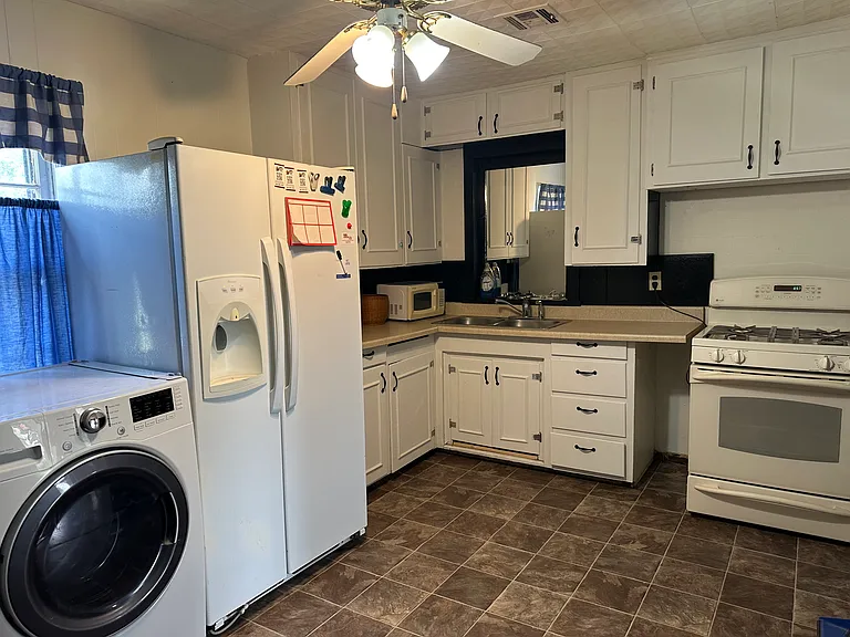 kitchen with washer, dryer, refrigerator and stove