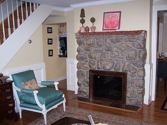 Living room with stone wood burning fireplace