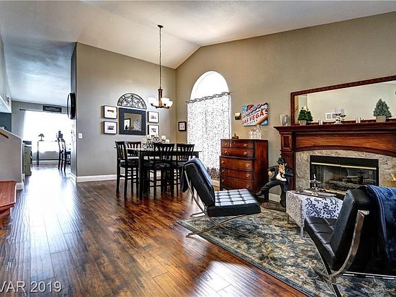 A sense of flowing space with vaulted ceilings, custom fireplace mantel, new lighting and fresh paint.