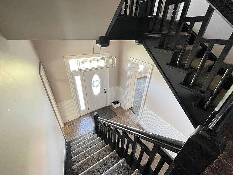 Beautiful victorian staircase leads from the front entryway to second floor bedrooms.