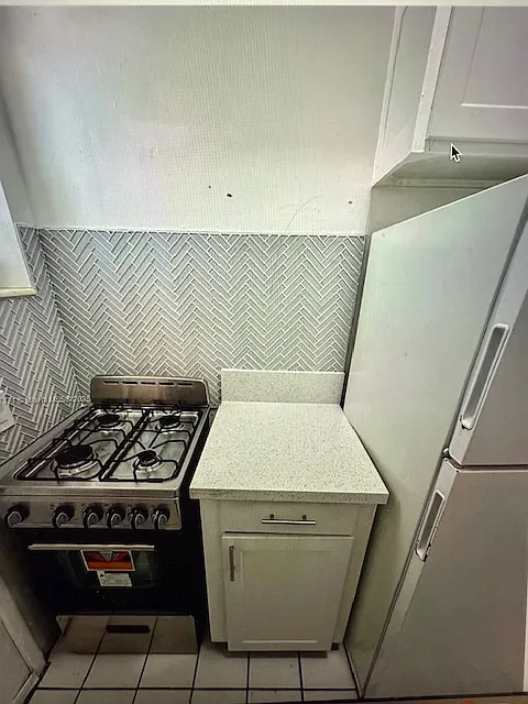 gas stove full size refrigerator and work space - lots of cabinet storage