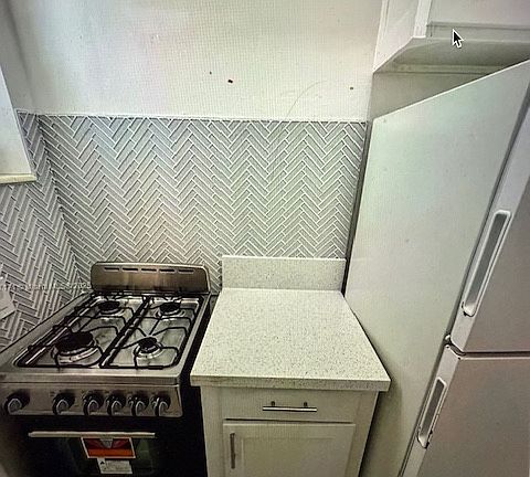 gas stove full size refrigerator and work space - lots of cabinet storage