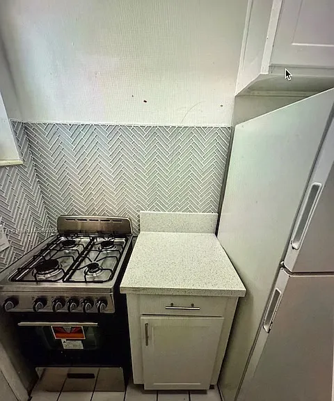 gas stove full size refrigerator and work space - lots of cabinet storage