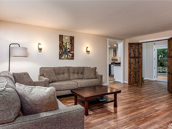 From the entrance looking into the living room and custom French doors to the den or meditation room. 