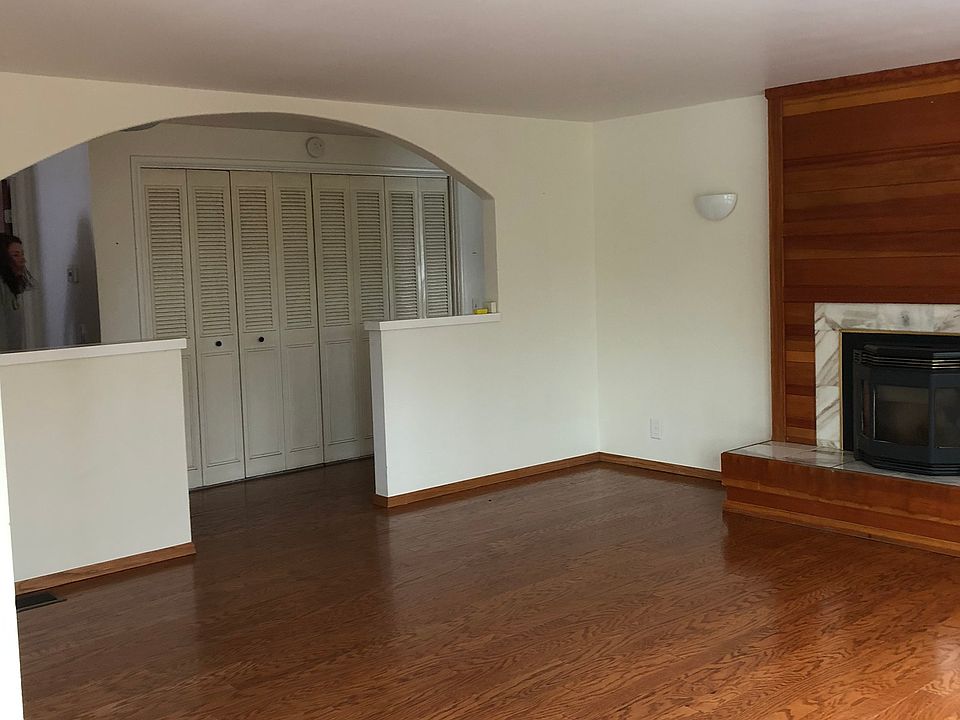Living room with pellet stove and a wall of closet storage