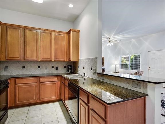 Roomy kitchen opens to living area. Granite counters and great storage are featured in the kitchen w