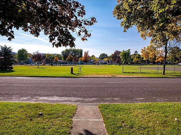 Thompson park with tennis courts, basketball, play structure and soccer/baseball field
