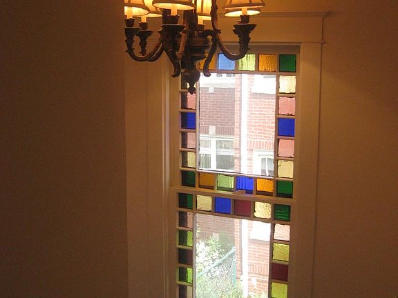 Front entry with Stained Glass window on stairway