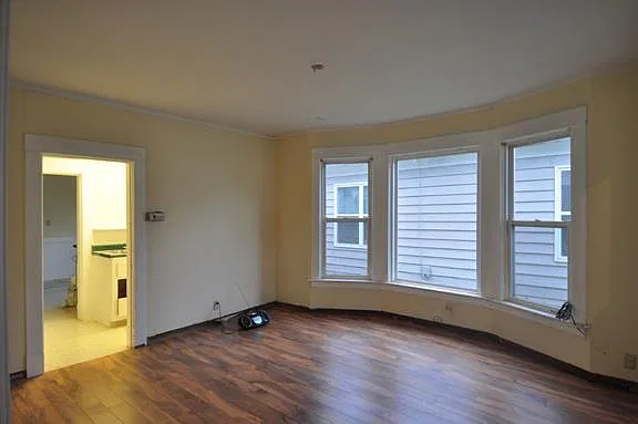 Living room leading to the pantry then the kitchen beyond.