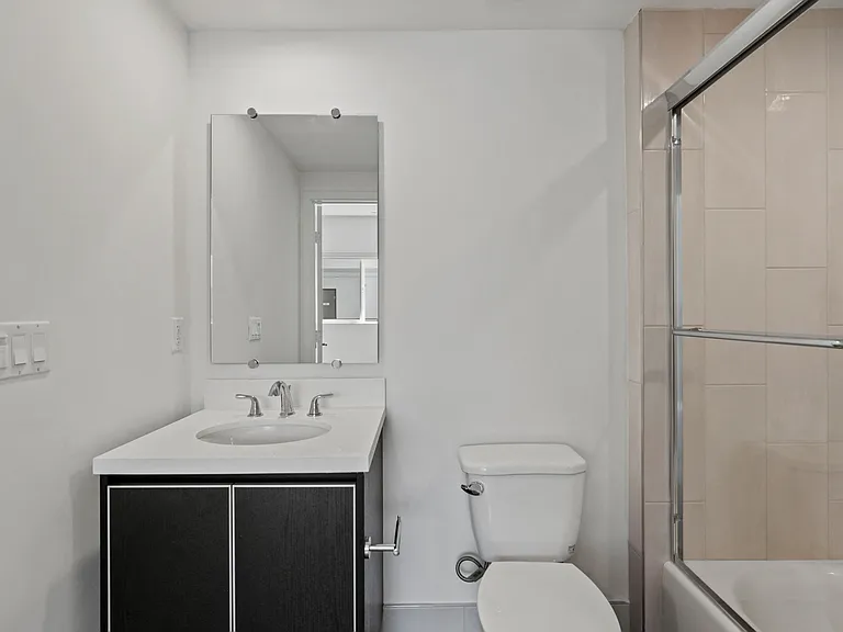 Bathroom with Shower Bath with Glass Door and Vanity Cabinet Storage